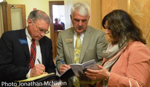 Sen. Taylor Brown, R-Huntley, reviews the vote tally with East Helena Superintendent Ron Whitmoyer and East Helena resident Karen Goldsberry after the House of Representatives voted 50-49 to pass Senate Bill 107 of second reading on Tuesday. (Jonathan McNiven photo)