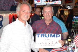 GOP candidates and fans watched returns from Tuesday's general election at Lone Wolf Energy in Billings. Billings residents Dave Malek, left, and retired U.S. Army veteran Dave Scott, right, pose with their Trump sign